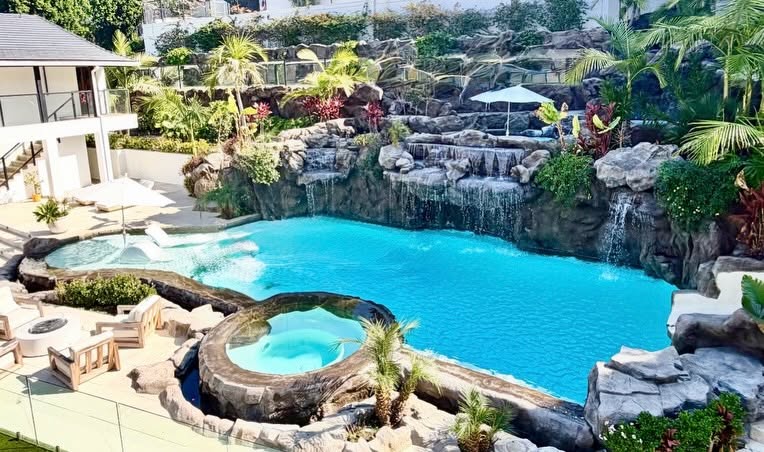 Award-winning hillside pool with 40-foot water slide, infinity edge and Baja ledge by Ultimate Water Creations