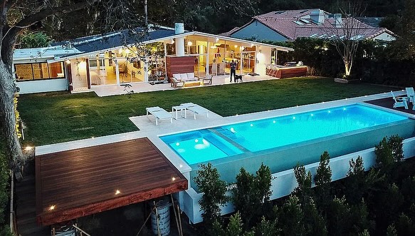 Modern hillside infinity pool with city view by day in Los Angeles